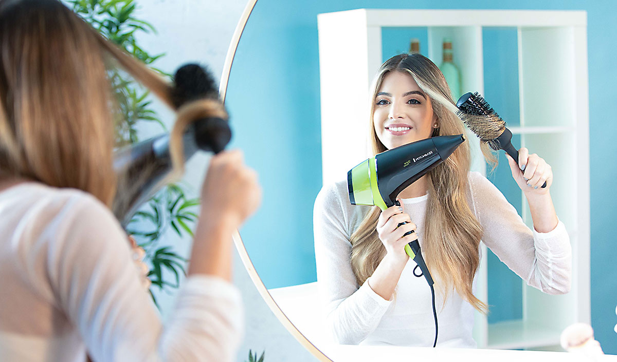 Mujer joven sonriente con cabello sin frizz, brillante y con volumen